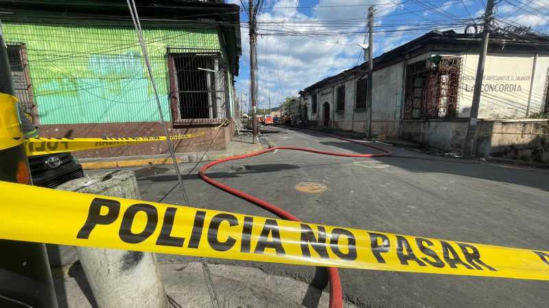 Equipos de Bomberos trabajan en la remoción de escombros tras el incendio que destruyó viviendas y locales en la 6.ª avenida Sur de San Salvador.
